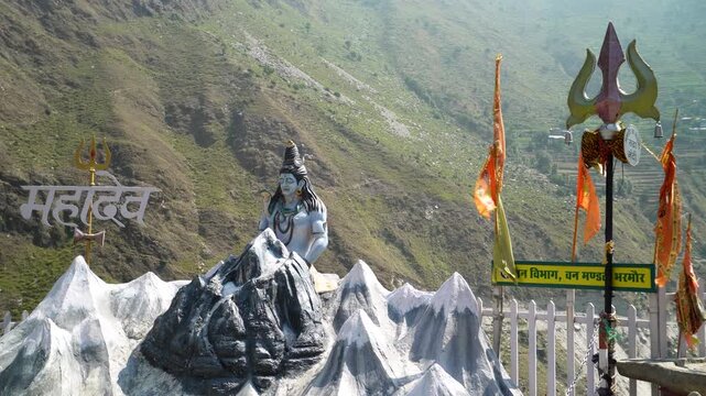 Statue of Lord Shiva with an engraving in Hindi meaning "Mahadev" at the first viewpoint for Kailash Parvat on the way to Bharmour Village, Chamba, Himachal Pradesh, India.