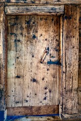 Old wooden door with iron door handle