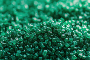 A macro shot showcasing uniform green polymer pellets, essential for industrial manufacturing, clearly highlighting their consistent size and texture for various applications.