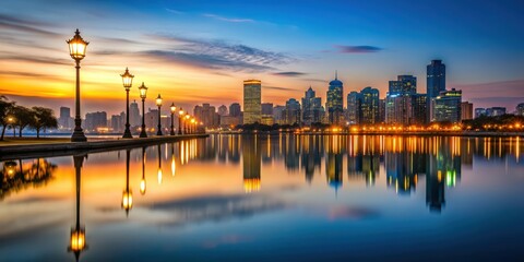 Fototapeta premium Photo of a city skyline at dusk with a focus on street lights reflecting on water, night, nocturnal, dawn, city