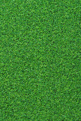 Obraz premium Artificial green grass mat, top view. Texture. Artificial turf, surface made of synthetic fibers. Flat green grass texture background. Short artificial grass golf surface
