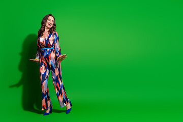 Full length photo of charming positive woman wear print overall having fun discotheque empty space isolated green color background