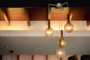 Four spherical glass pendant lights hanging from ceiling.