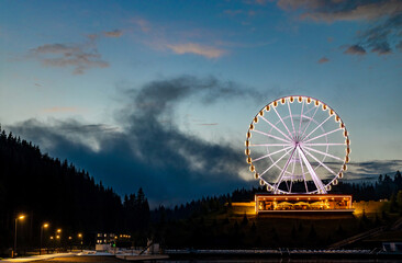 Night landscape, Ferris wheel with beautiful illumination at night. Attraction in Bukovel.
