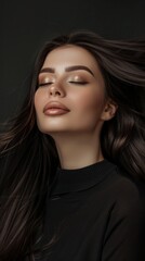 Portrait of a woman with olive skin, red lips, and long hair. Makeup accentuates eyes and face. Black backdrop with subtle lighting.