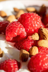 Delicious yogurt with strawberries and almonds, closeup, macro.