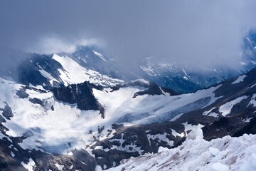 mountain landscape, rocks and glaciers among clouds