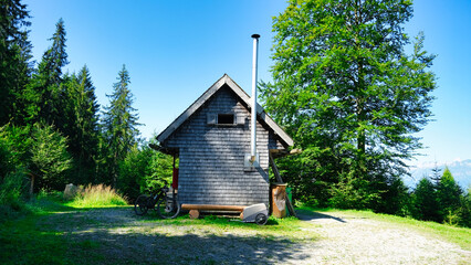 Fototapeta premium A mountain hut with an external chimney in clear view