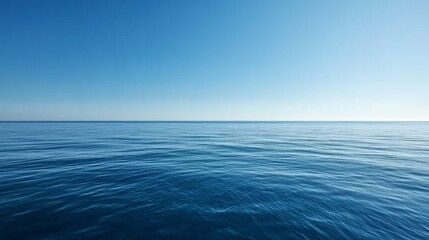 Obraz premium Calm ocean under a clear blue sky during midday