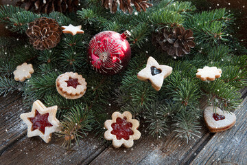 Traditional Tasty Homemade Linzer cookies with jam and Christmas decorations.