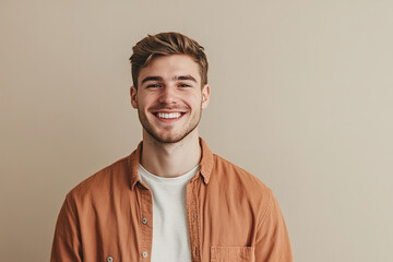 A portrait of a happy young man standing casually exudes a relaxed and cheerful vibe