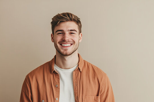 A portrait of a happy young man standing casually exudes a relaxed and cheerful vibe