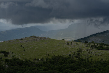 Dark storm clouds hang threateningly over the Croatian mountains.