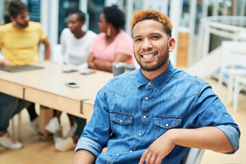 Fototapeta premium Portrait, creative and happy business man at startup for career, coworking and smile for opportunity. Internship, face and confident entrepreneur, employee and writer with team at meeting in company