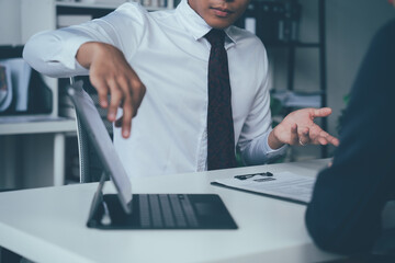 Business Presentation: Focused on details, a businessman confidently presents a tablet during a meeting, showcasing his expertise and professionalism.  A captivating image for business communication. 