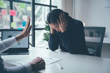 A young woman applies for a job with her hands over her ears but doesn't hear back from her employer.