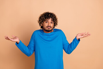 Photo of confused nice man wear trendy blue clothes no answer isolated on beige color background
