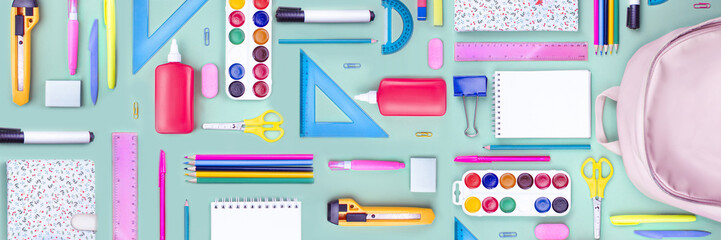 Composition of multi-colored stationery items, school supplies laid out on the table. office, school FLAT LAY . Back to school, banner, school bag