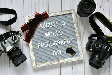 August 19 World Photography Day old film SLR camera and modern DSLR negatives SD cards