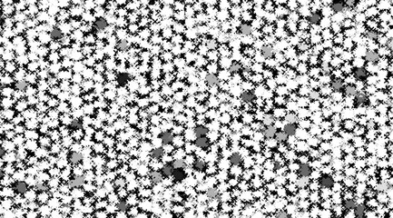 A black and white photo of a patterned background with a few white dots scattered throughout. The photo has a somewhat abstract and artistic feel to it