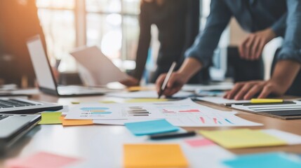 Innovative young professionals engaged in a creative workshop, with digital tools and brainstorming materials spread out on a contemporary office table.