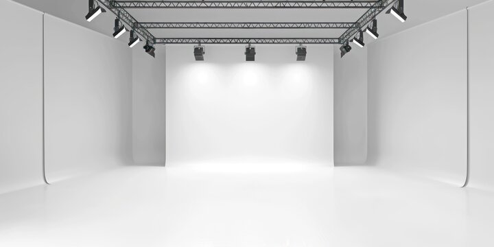 Professional photography studio setup with white cyc wall, overhead lighting, and soft shadows