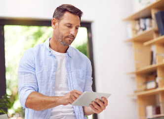 Remote work, tablet and man in home for online networking, planning and internet. Entrepreneurship, freelance person in business and digital tech for research project, website and report in morning © ThurstanBuyout/peopleimages.com