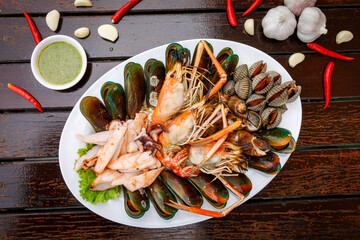 Seafood plate with shrimp shellfish crab squid cockle spotted babylon with seafood sauce chili...