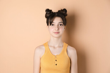 Obraz premium Portrait of cute teenage girl on beige background