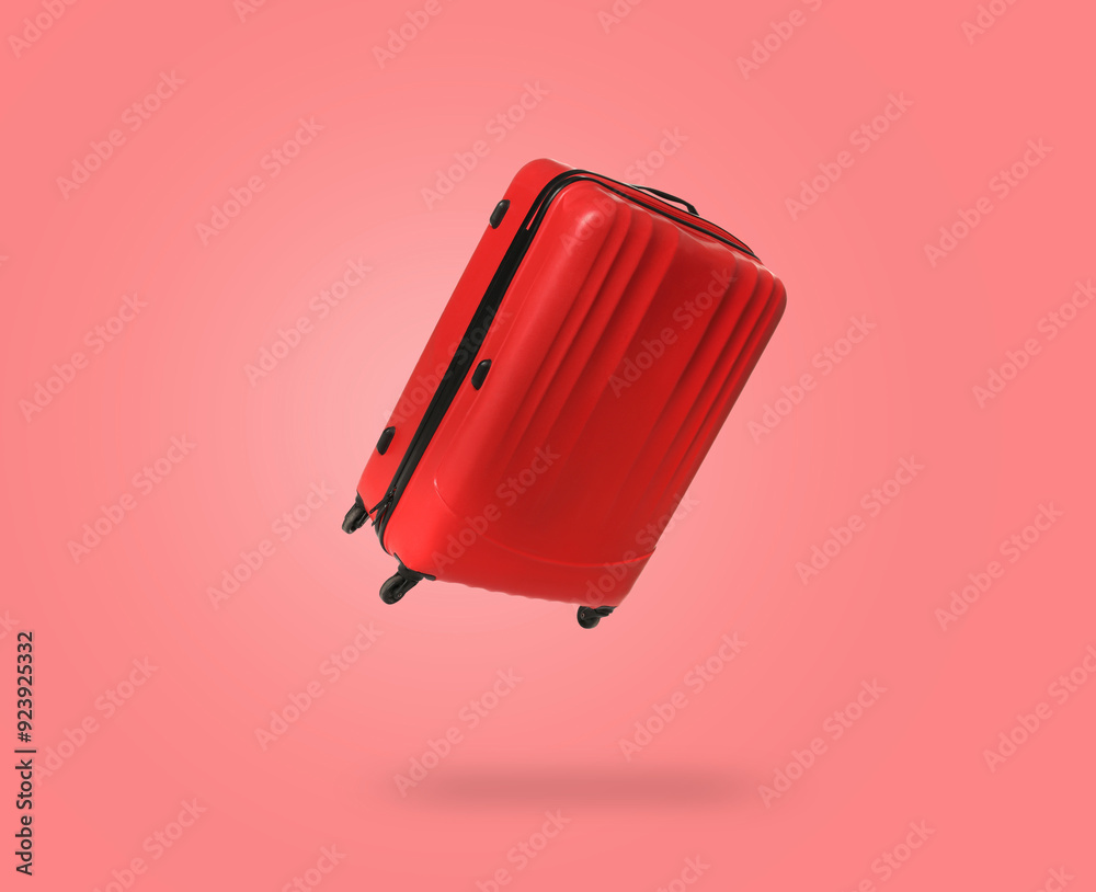 Poster Red suitcase in air on coral background