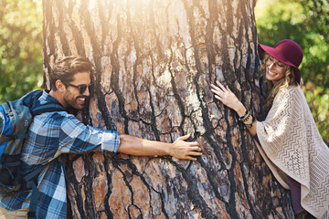 Fototapeta premium Couple, hug tree and activists in outdoor nature, sustainability support and love woods together. People, embrace and forest for ecosystem travel adventure, environment care and countryside trekking