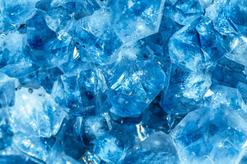 Blue Crystal Mineral Stone. Gems. Mineral crystals in the natural environment. Texture of precious and semiprecious stones. Seamless background with copy space colored shiny surface of precious stones