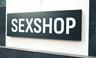 Adult Store Signage: Black and White 'SEXSHOP' Sign on Building Exterior