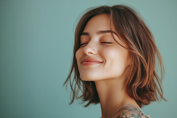 Fototapeta premium A close up of a woman's face with tattoos and her eyes closed