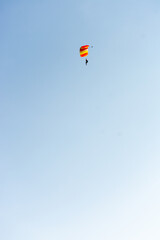 Parachutter with yellow and red schute