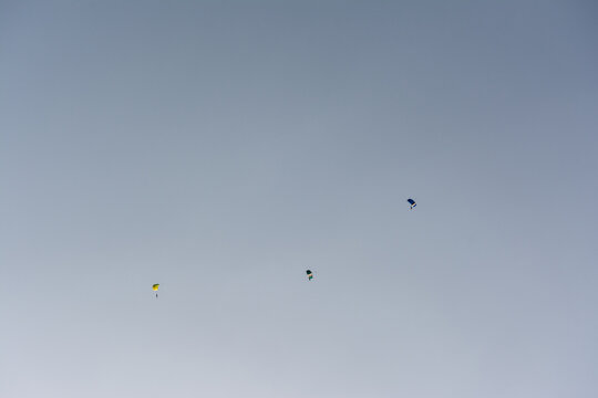 Three skydiving shutes in the sky