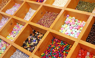 Variety of Colors and Shapes of Beads in Wooden Compartment Display Boxes for DIY Accessories