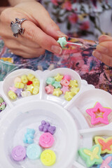 Fingers Putting a Bead on String for Making Beaded Accessories