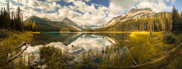 A beautiful landscape with a lake and mountains in the background