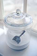 Glass jar containing washing soap on a shelf in the Laundry room 