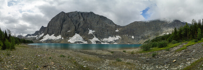 A mountain range with a lake in the foreground