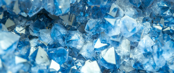 Blue Crystal Mineral Stone. Gems. Mineral crystals in the natural environment. Texture of precious and semiprecious stones. Seamless background with copy space colored shiny surface of precious stones