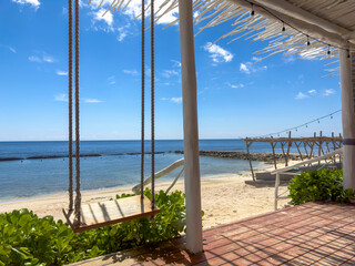 Experience pure bliss in the Mayan Riviera. This wooden beach bar offers the perfect spot to relax in a hammock, sipping on a tropical drink while gazing out at the stunning horizon.