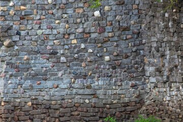 The wall of the old fortress made of stone