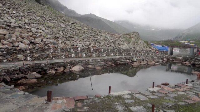 Gauri Kund, a sacred pond dedicated to Hindu goddess Gauri Mata, where devotees offer prayers during the Mani Mahesh Kailash Yatra in Chamba Valley, higher Himalayas.