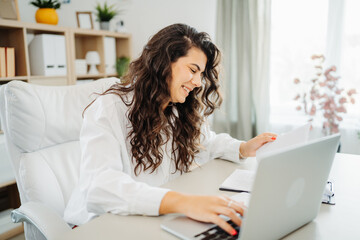 Young caucasian business woman working in office on laptop