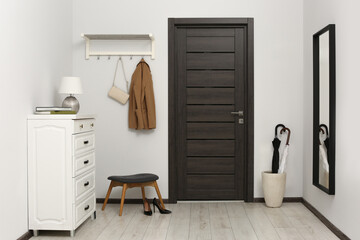 Stylish hallway with chest of drawers and mirror. Interior design