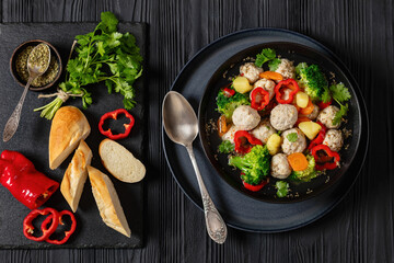 chicken meatball soup with vegetables in a bowl