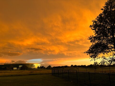 Spectacular Kansas Sunset. This completely unfiltered orange sunset was possible because light rain was falling from the clouds (evaporating just below) while the sun was right on the horizon. 