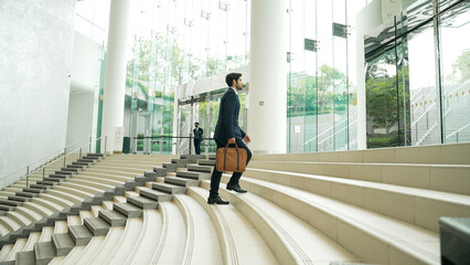 Professional business man going up the stairs. Successful man going up the stairs while explore a...